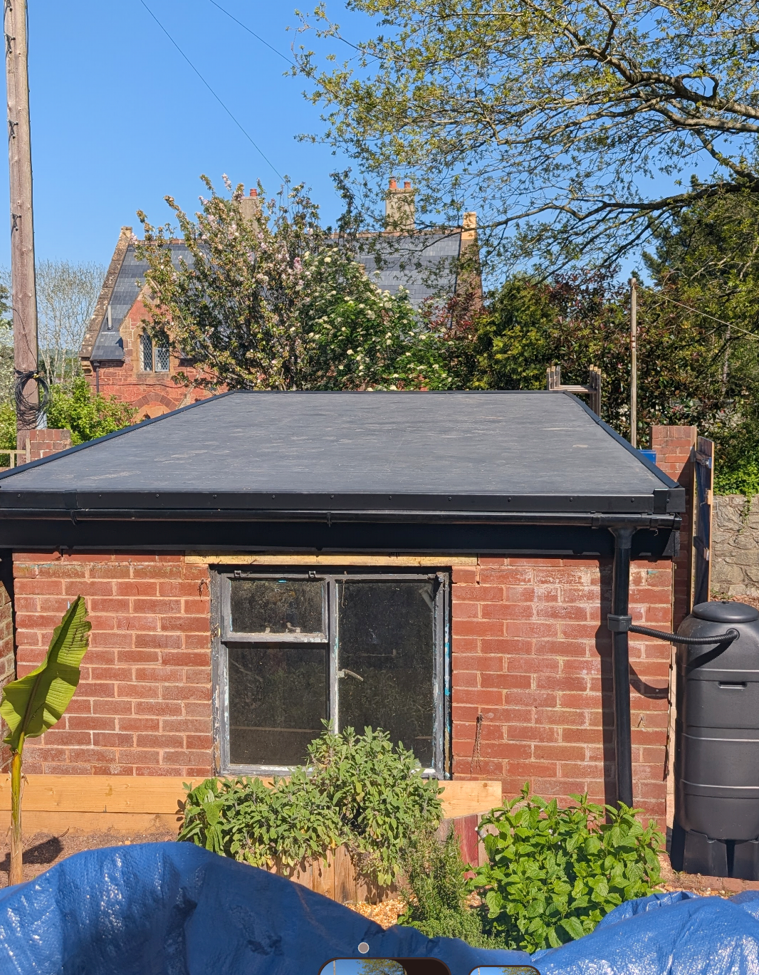 A new black EPDM rubber flat roof fitted to a brick extension in Exeter